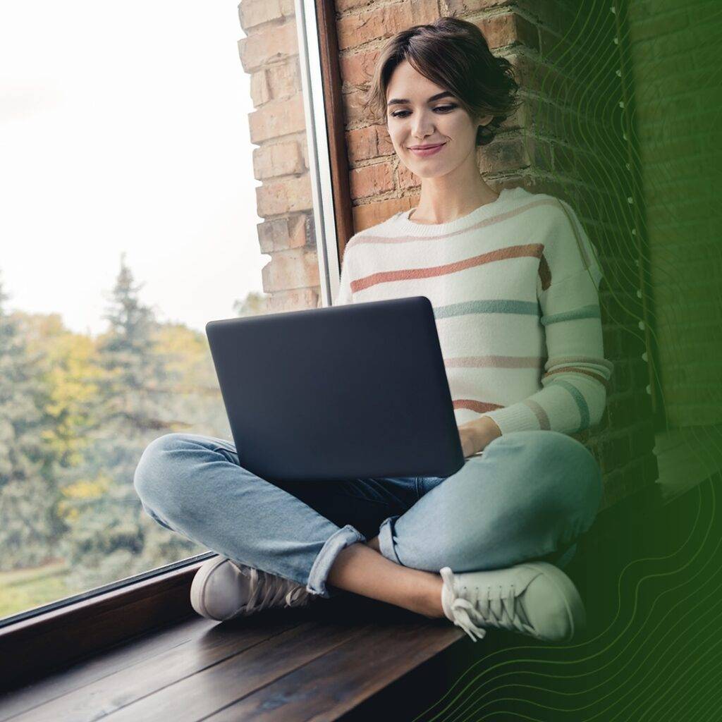 A woman using her laptop to attend online school.